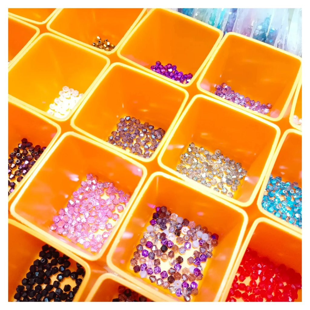 4200pcs 42 Packets 100pcs ea 4mm Bicone Beads Mixed Colours Set – Orange container with compartments filled with various colored beads and sequins on a white background