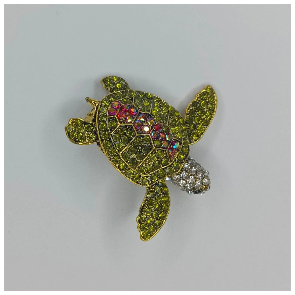 Crystal Adorned Sea Turtle Brooch with Rhinestones – Decorative turtle brooch with gemstones on a gray background