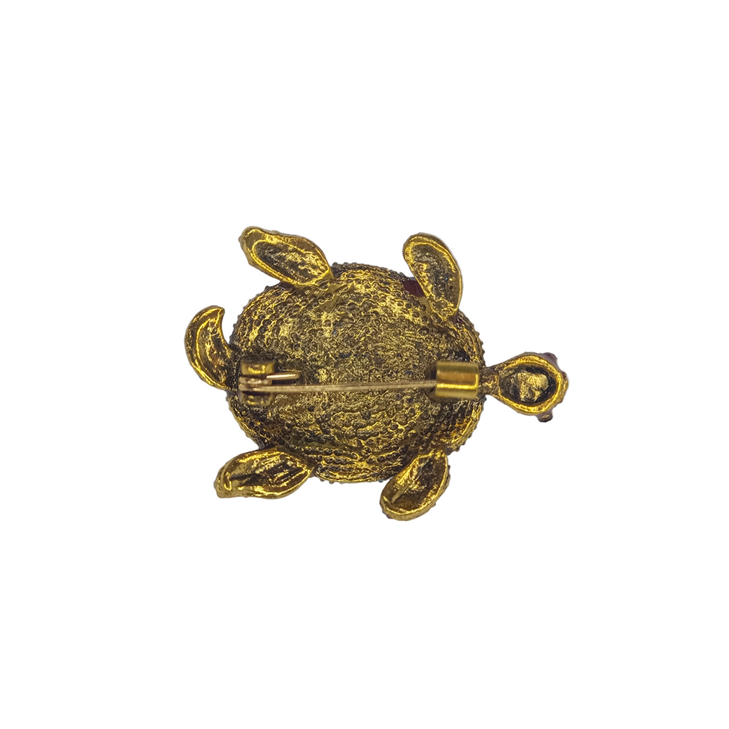Crystal Adorned Sea Turtle Brooch with Rhinestones – Gold turtle-shaped brooch on a gray background