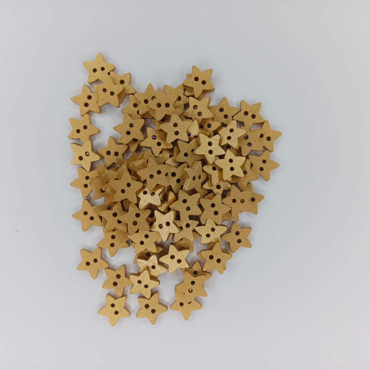 Star Wood Buttons 13mm 2 Holes – Silver & Gold – A pile of small star-shaped wooden buttons with two holes, arranged on a plain light gray background.